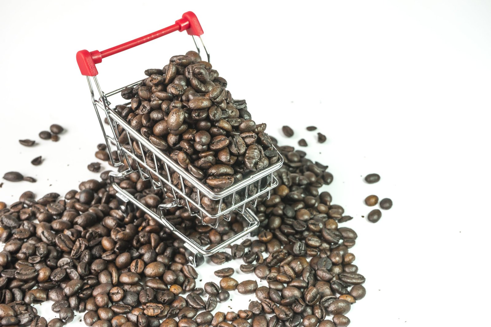 close up coffee beans shopping cart against white background scaled