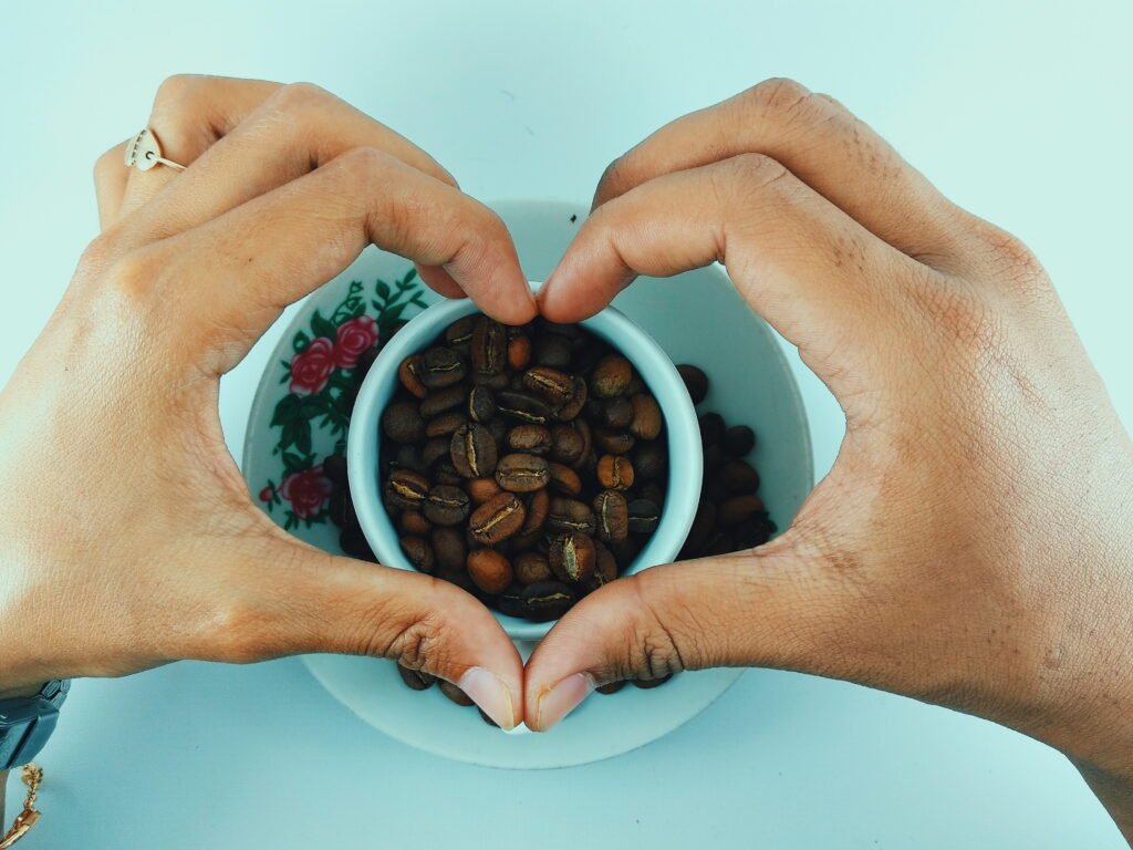 close up hand holding coffee beans