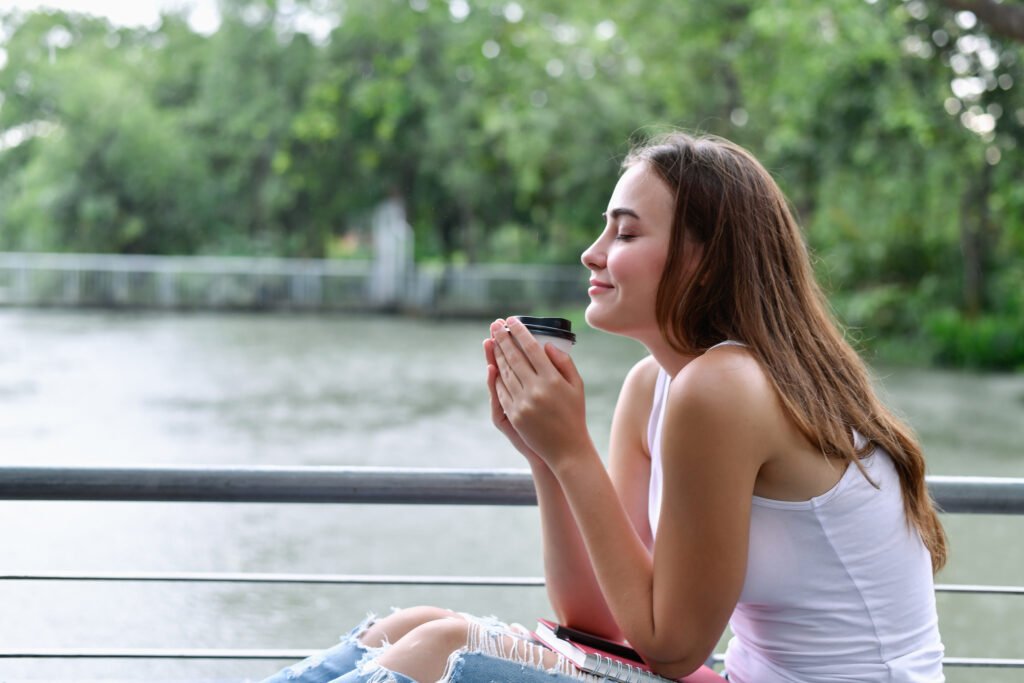 close up smiling woman holding drink