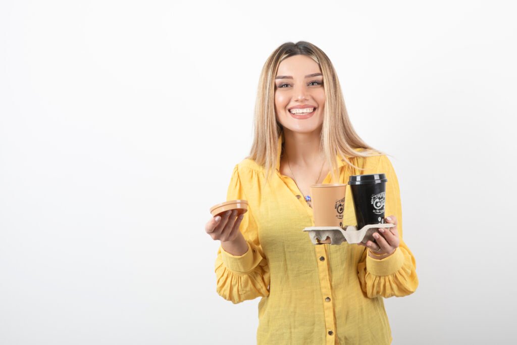 image young woman holding cups coffee while smiling